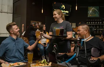 Waitress serving beer to a table